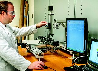 Dr Daniel Salas demonstrates how the hidden magnetic tag can store a cache of information within an item. Image: Texas A&M Engineering