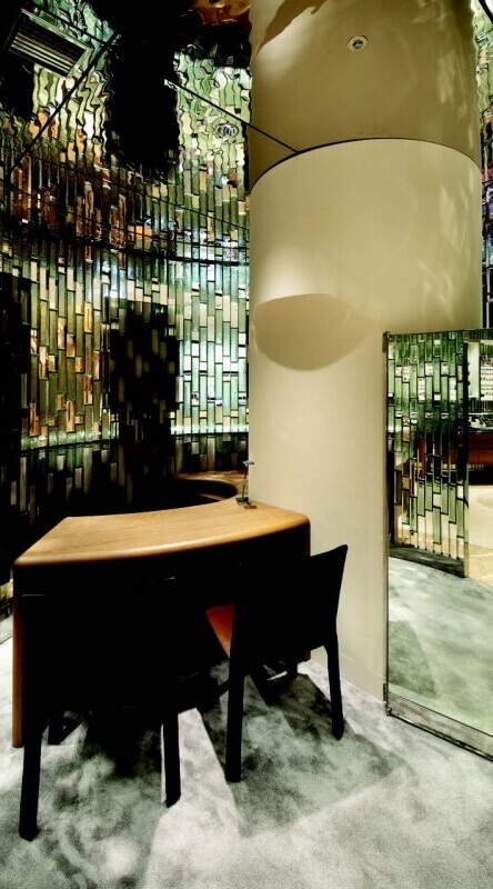 Curved glass partitions create semi-private areas for customers inside the Isetan shop.