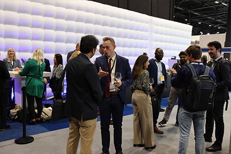 Delegates and exhibitors mingling outside one of the Conference Arenas.