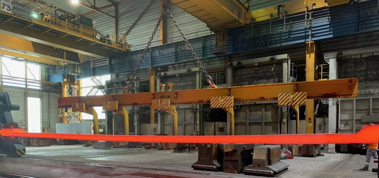 Figure 3. Final forging operations of the 15 m length ITER CS tie plates. Image courtesy of Rolf Kind GmbH.