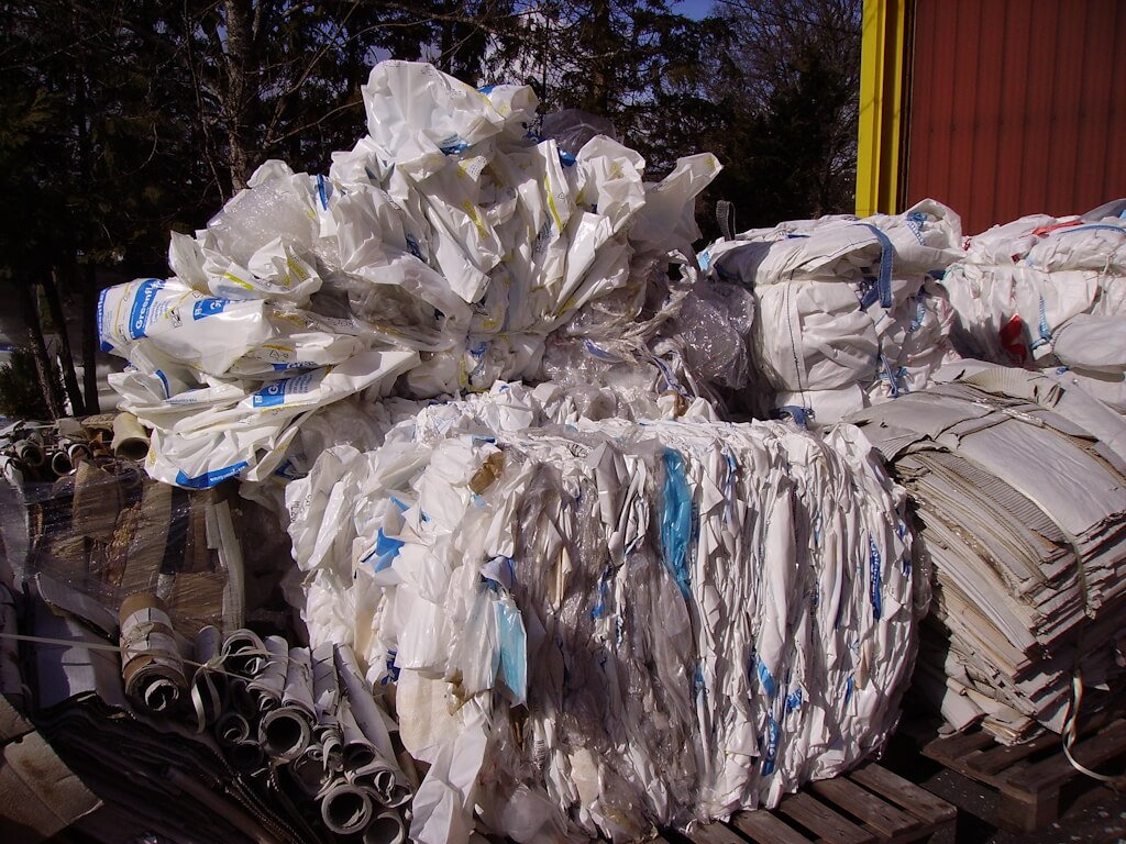 Plastic bags and cardboard waiting to be transported for reprocessing. Photo: wikipedia, Cjp24.