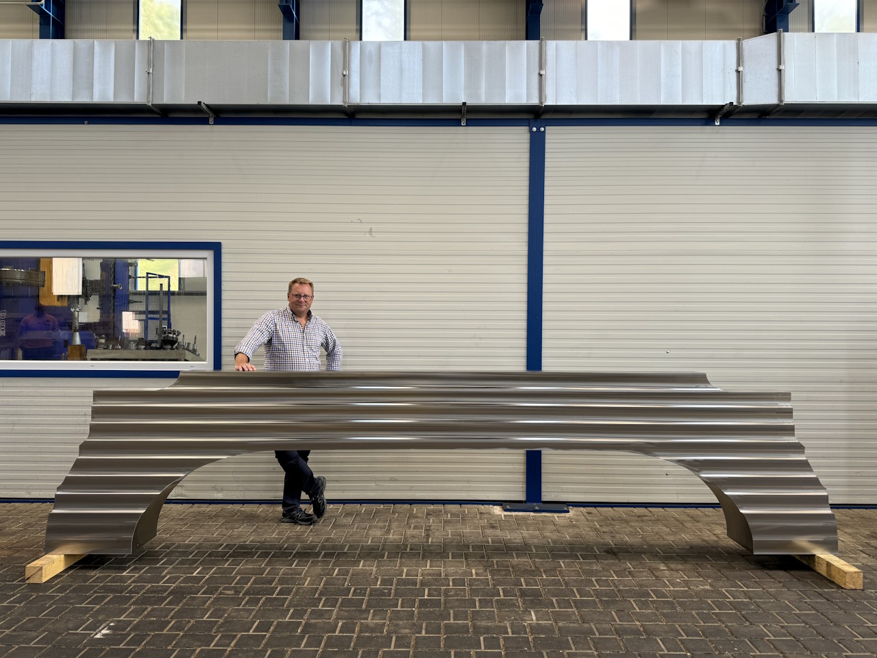 Markus Kind with a large stainless steel forging for a fusion machine magnet production. Photo courtesy of Rolf Kind. Markus Kind with a large stainless steel forging for a fusion machine magnet production. Photo courtesy of Rolf Kind.
