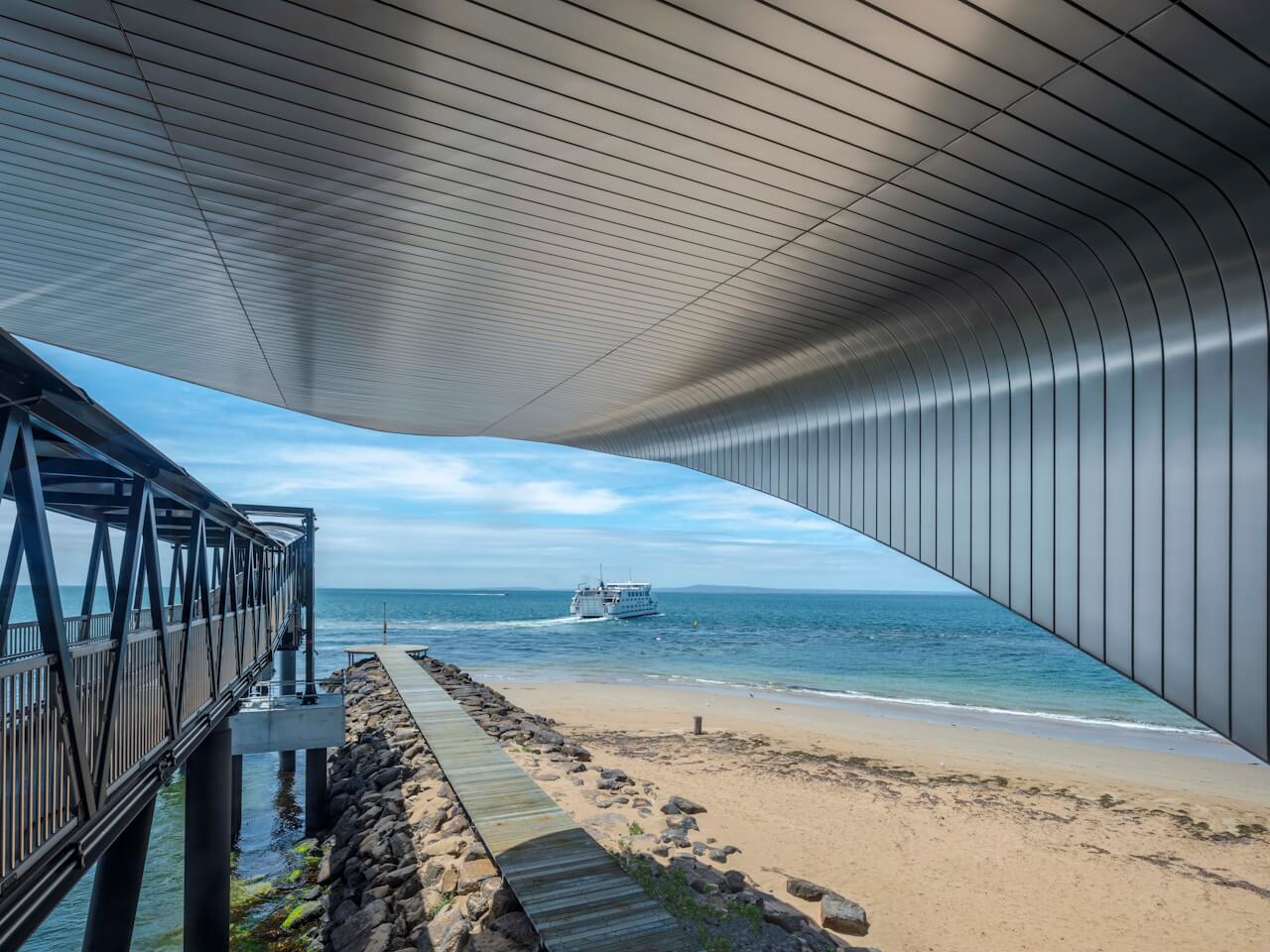 The roof stretches gracefully with a nod to the curved profile of this unique stretch of coastline. ©Tim Griffith. All rights reserved. The roof stretches gracefully with a nod to the curved profile of this unique stretch of coastline. ©Tim Griffith. All rights reserved.